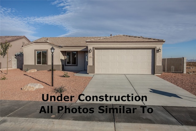 7454 E Sawmill Dr, Kingman, AZ 86401 - single story home featuring driveway, a garage, stucco siding, and a tiled roof