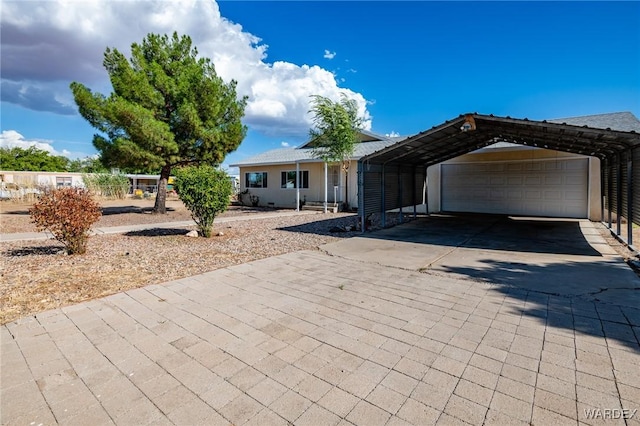 ranch-style home with a garage and a carport