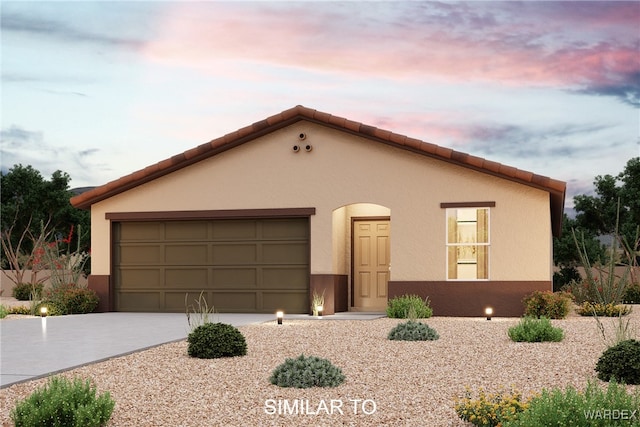 view of front facade featuring driveway, a tiled roof, an attached garage, and stucco siding