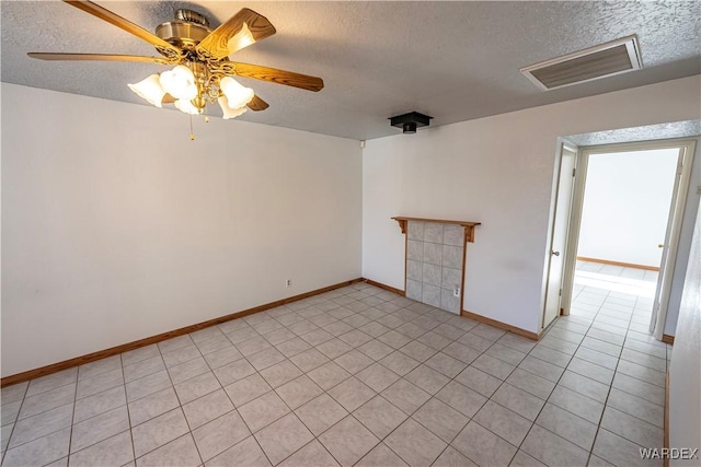 unfurnished room featuring visible vents, a textured ceiling, and baseboards