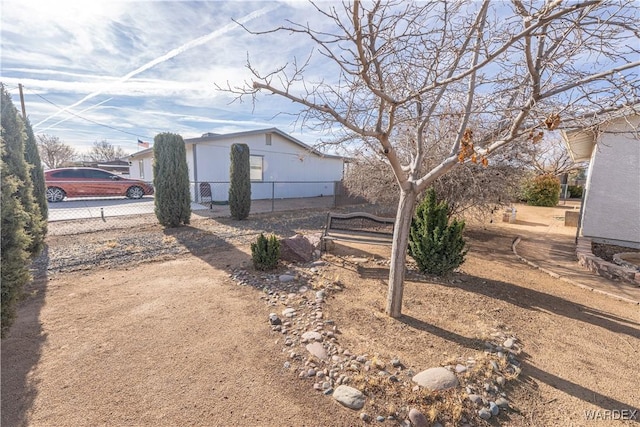 exterior space with driveway and fence