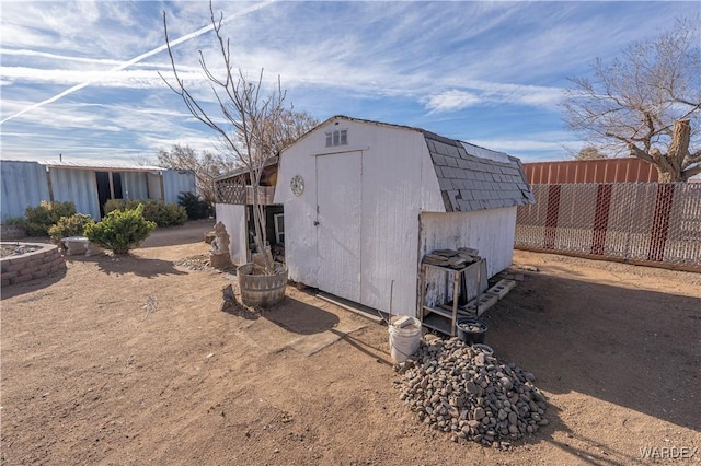 view of shed featuring fence