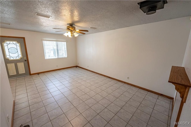 foyer entrance with a ceiling fan, visible vents, a textured ceiling, and baseboards