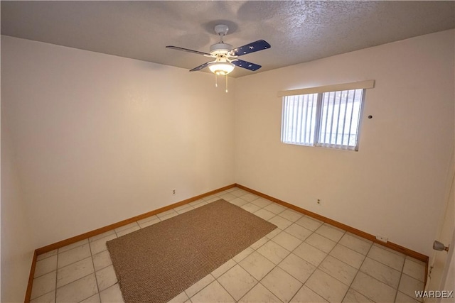 unfurnished room with a ceiling fan, a textured ceiling, baseboards, and light tile patterned floors