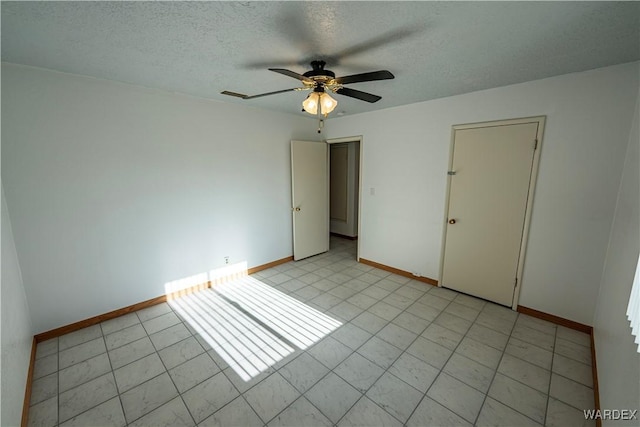 unfurnished bedroom featuring a ceiling fan, baseboards, and a textured ceiling