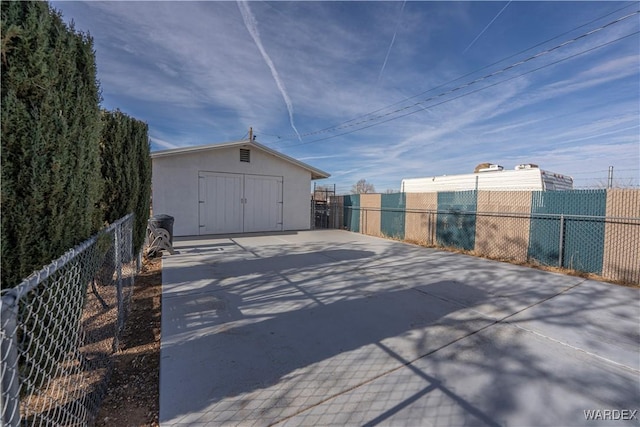 view of outbuilding with fence and an outdoor structure