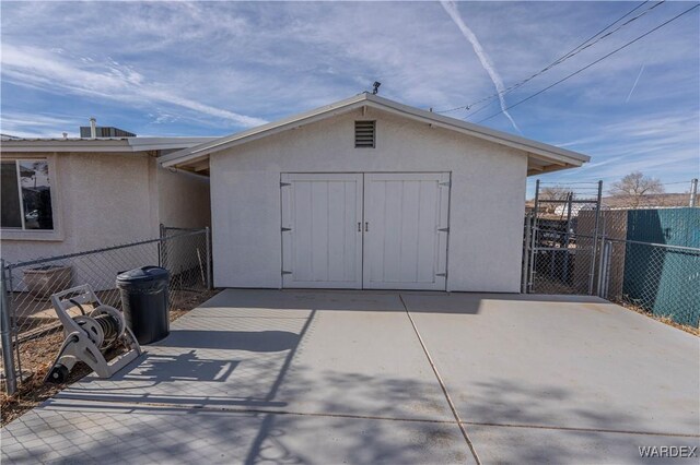 view of outbuilding featuring an outbuilding and fence