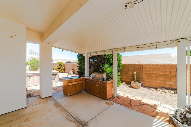 view of patio with a grill, an outdoor kitchen, and a fenced backyard