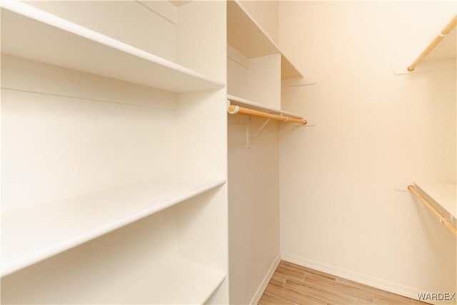 spacious closet with light wood-style floors