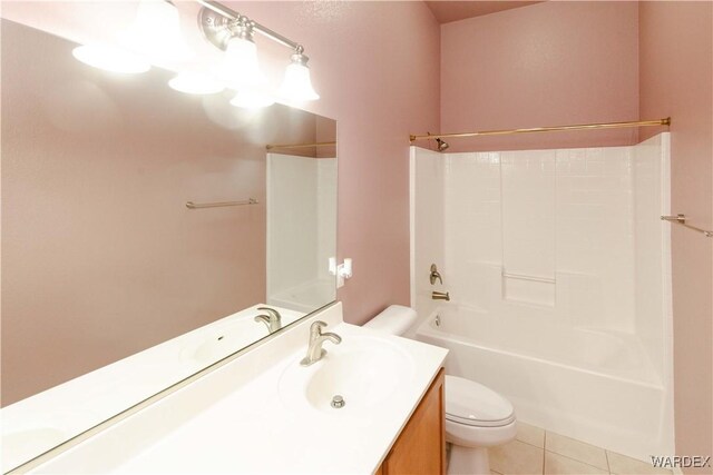 bathroom featuring washtub / shower combination, vanity, tile patterned flooring, and toilet