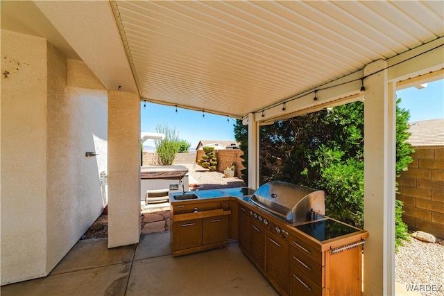 view of patio / terrace with a hot tub, fence, grilling area, and area for grilling