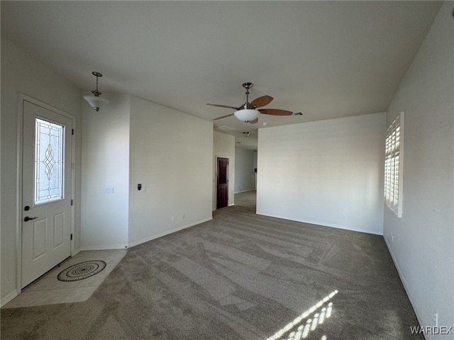 interior space with baseboards, plenty of natural light, and light colored carpet