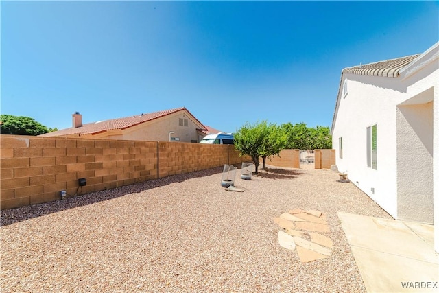 view of yard featuring a patio area and a fenced backyard