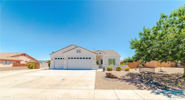 view of front facade featuring a garage, a fenced front yard, concrete driveway, and stucco siding