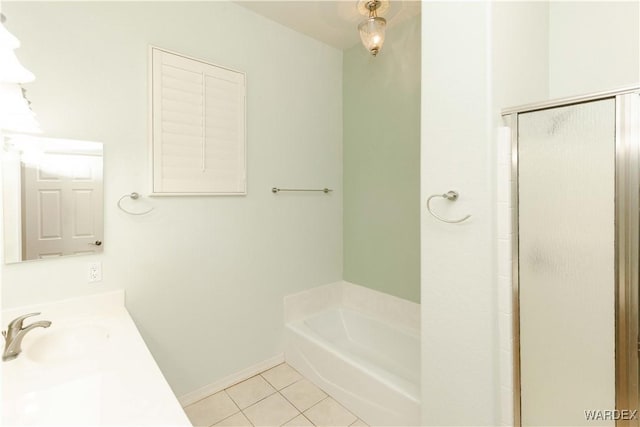 bathroom with a garden tub, tile patterned flooring, a sink, baseboards, and an enclosed shower