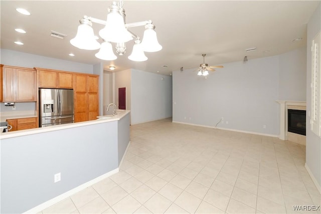 kitchen featuring open floor plan, light countertops, visible vents, and stainless steel fridge with ice dispenser