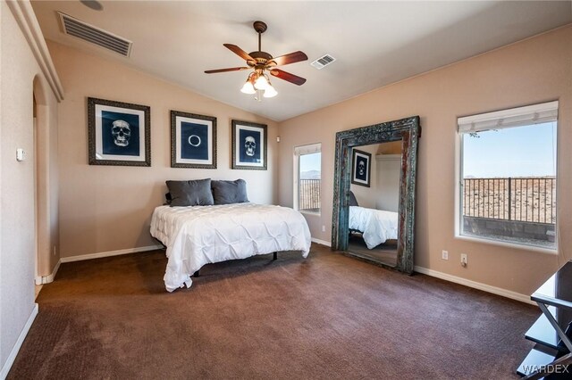 bedroom with lofted ceiling, baseboards, visible vents, and dark colored carpet