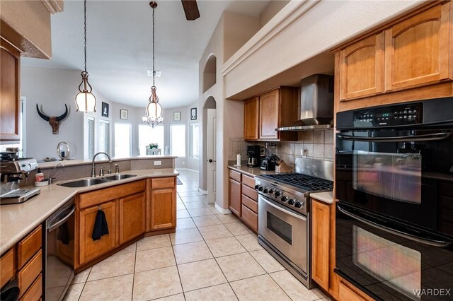 kitchen featuring black appliances, wall chimney exhaust hood, light countertops, and a sink