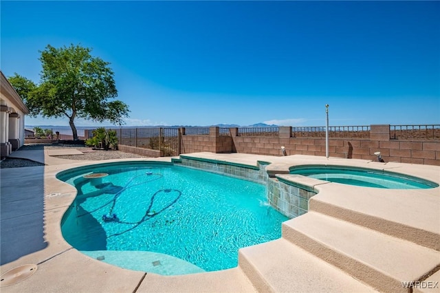 view of pool with a fenced in pool, a fenced backyard, and an in ground hot tub