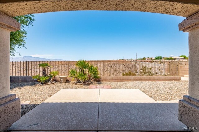 view of patio featuring a fenced backyard and a mountain view