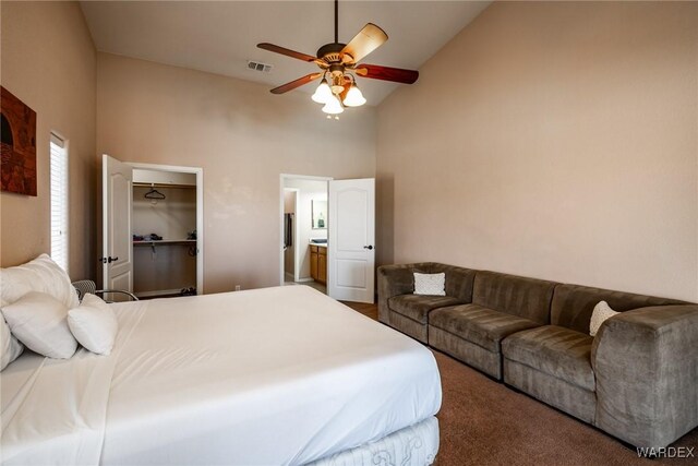 bedroom with visible vents, a ceiling fan, a spacious closet, carpet flooring, and high vaulted ceiling