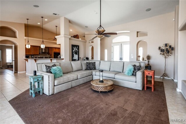 living room with light tile patterned floors, high vaulted ceiling, visible vents, and a ceiling fan