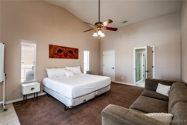 carpeted bedroom with high vaulted ceiling, visible vents, and baseboards