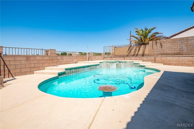 view of pool featuring a patio area, a fenced backyard, and a pool with connected hot tub