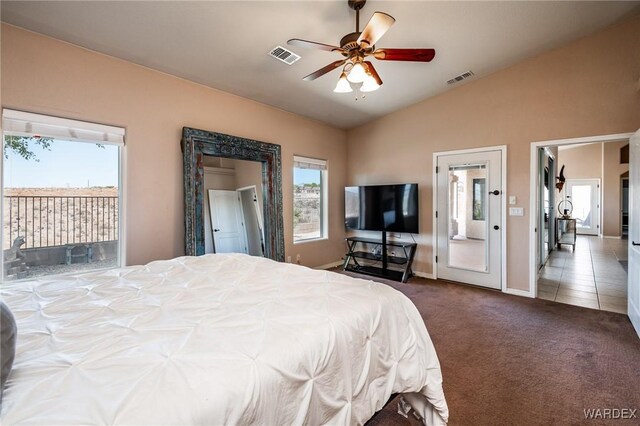 bedroom with dark colored carpet, access to outside, visible vents, and lofted ceiling