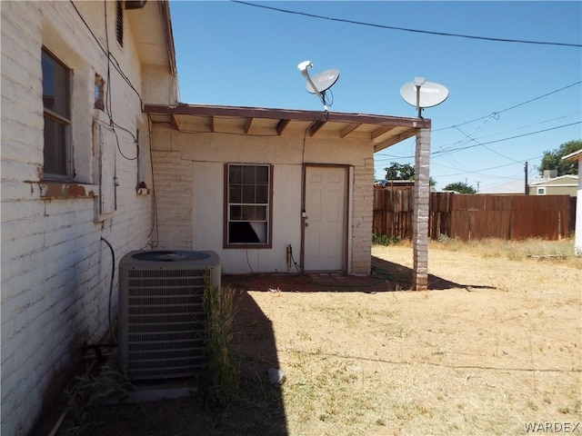 exterior space with fence and central AC unit