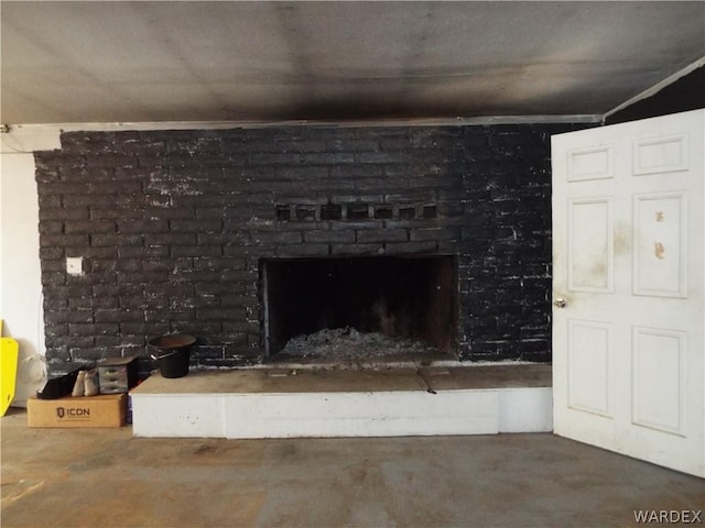 details featuring concrete floors and a brick fireplace