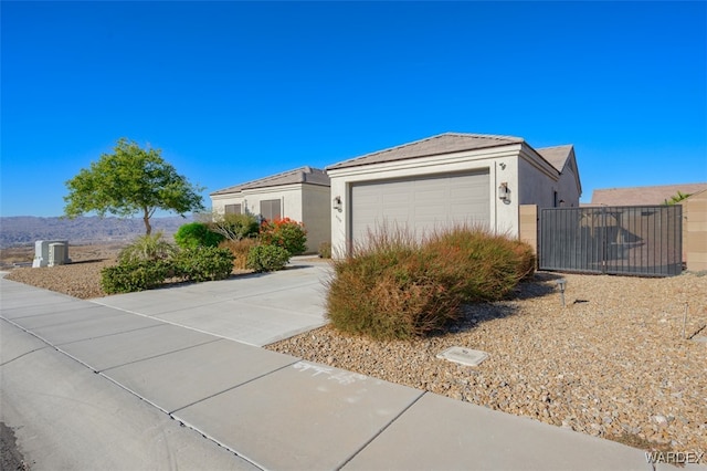 view of front of home with driveway, an attached garage, and stucco siding