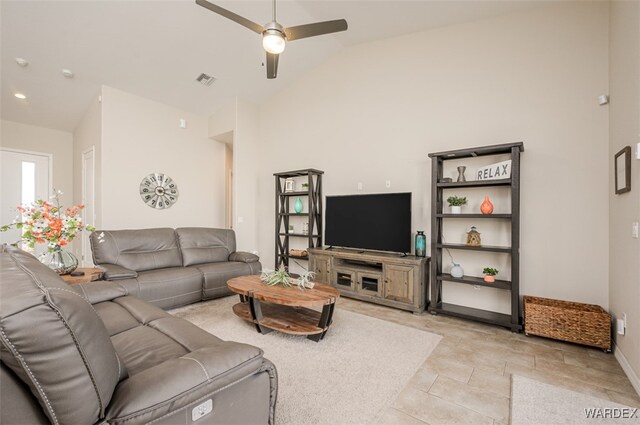 living room featuring lofted ceiling, baseboards, visible vents, and a ceiling fan