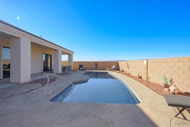 view of swimming pool featuring a fenced backyard, a fenced in pool, and a patio