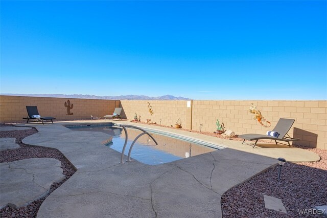 view of pool featuring a patio area, a fenced backyard, and a fenced in pool