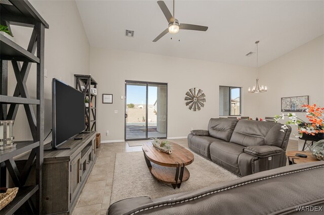 living room with high vaulted ceiling, baseboards, visible vents, and ceiling fan with notable chandelier