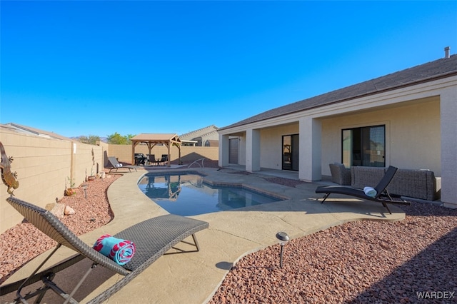 view of pool featuring a gazebo, a patio, a fenced backyard, and a fenced in pool