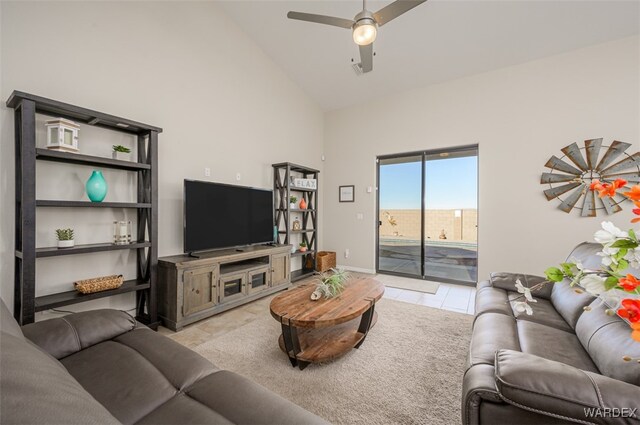 living room with high vaulted ceiling, light tile patterned flooring, baseboards, and a ceiling fan