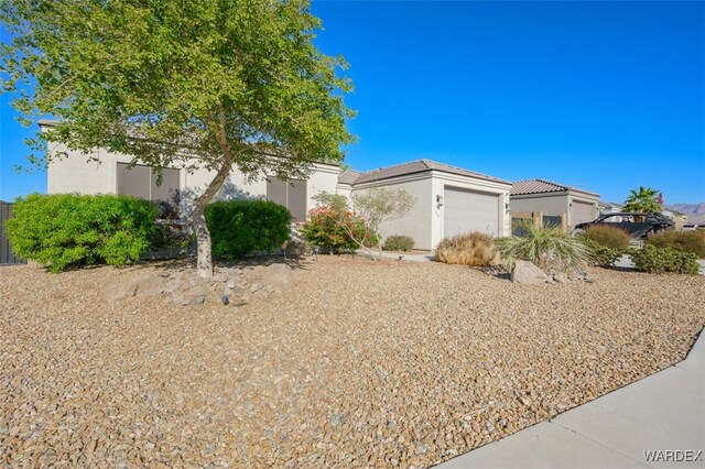 view of front facade with an attached garage and stucco siding