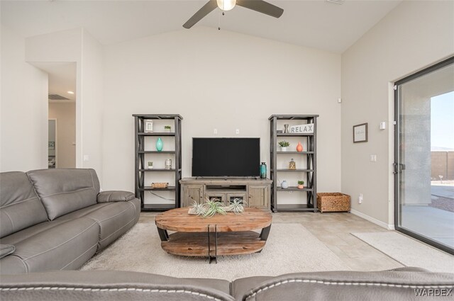 living area featuring lofted ceiling, baseboards, and a ceiling fan