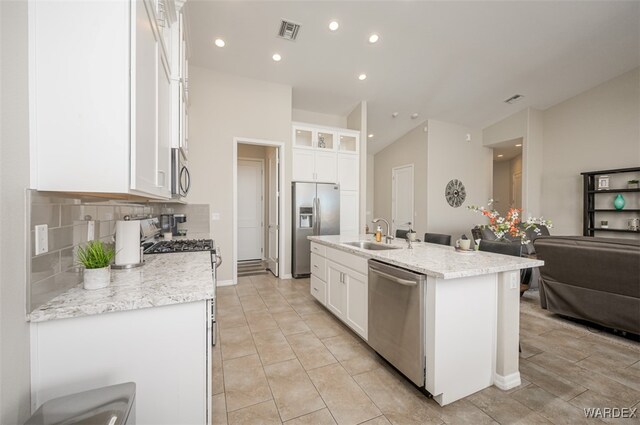 kitchen with a kitchen island with sink, appliances with stainless steel finishes, visible vents, and white cabinetry