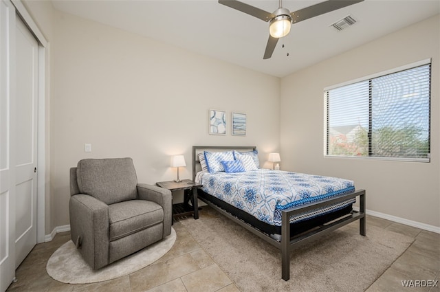 bedroom with a ceiling fan, visible vents, baseboards, and light tile patterned floors