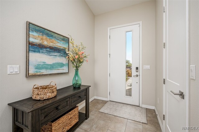 foyer with baseboards and light tile patterned floors