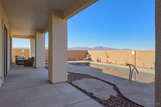 view of patio / terrace featuring a fenced backyard and a mountain view