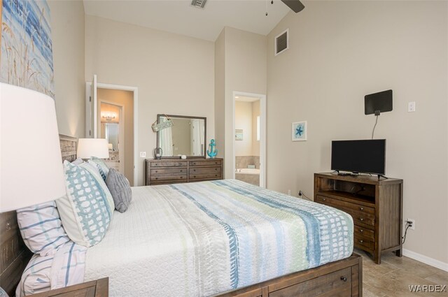 bedroom featuring ensuite bathroom, high vaulted ceiling, visible vents, and baseboards