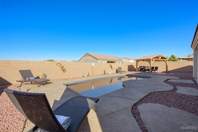 view of swimming pool featuring a fenced backyard, a fenced in pool, a patio, and a gazebo