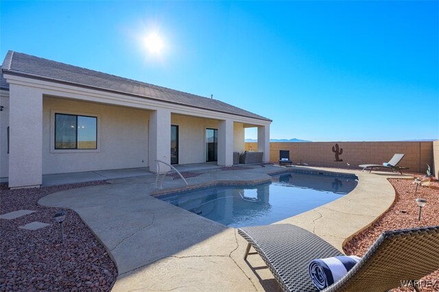 view of swimming pool featuring a fenced in pool, a fenced backyard, and a patio