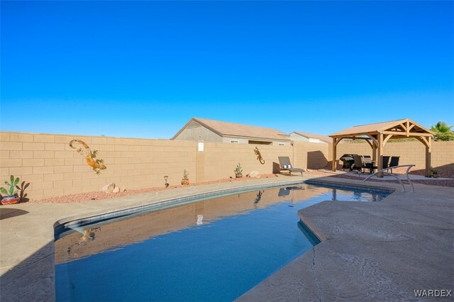 view of pool with a gazebo, a patio area, a fenced backyard, and a fenced in pool