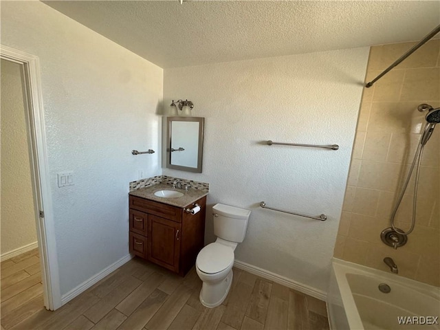 full bathroom featuring toilet, tub / shower combination, vanity, a textured ceiling, and wood finished floors