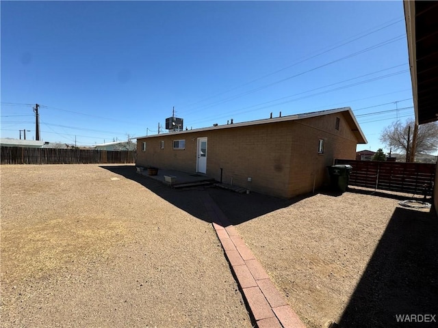 back of house featuring fence private yard and central air condition unit